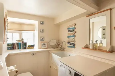 a bathroom with a sink and a mirror at Homelands in Port Isaac
