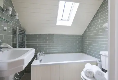 a bathroom with a sink and a bath tub at Poplar Cottage in Port Isaac