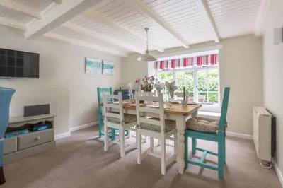 a dining room with a table and chairs at Poplar Cottage in Port Isaac