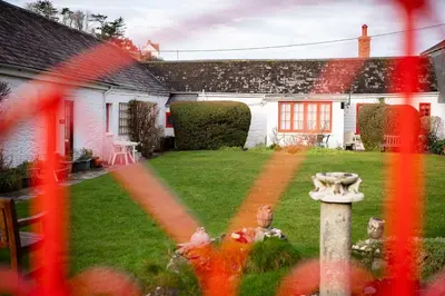 a house with a fire hydrant in the yard at Portcor in Port Isaac