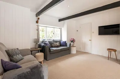 a living room with a couch and a tv at Portcor in Port Isaac