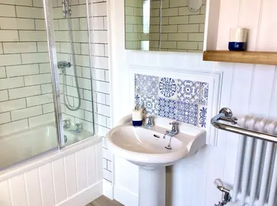 a bathroom with a sink and a shower at Ensuite room only in beautiful former farmhouse garden and parking in St Ives
