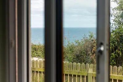 a view of the ocean from a window at White Horses in Port Isaac