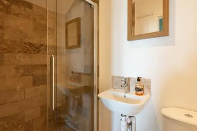 a bathroom with a sink and a shower at White Horses in Port Isaac