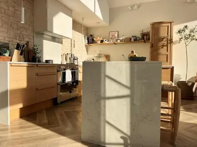 a kitchen with a counter in the middle of a room at SeaNest and cabin, walk to beach in St. Agnes
