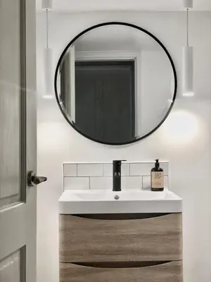 a bathroom with a sink and a mirror at SeaNest and cabin, walk to beach in St. Agnes