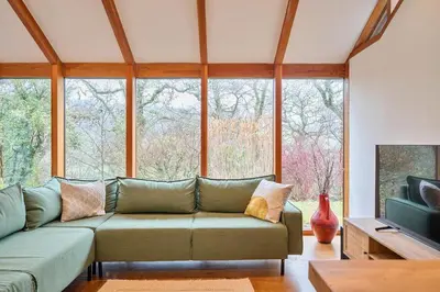 a living room with a couch and a large window at 2 Bed in Tresarrett oc-b34255 in Blisland