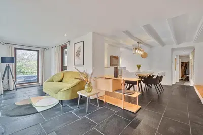 a living room with a couch and a dining room at 4 Bed in Tresarrett oc-b34254 in Blisland