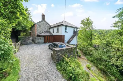 an external view of a house with a garden at 4 Bed in Tresarrett oc-b34254 in Blisland