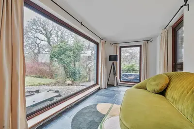 a living room with a couch and a large window at 4 Bed in Tresarrett oc-b34254 in Blisland