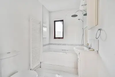 a white bathroom with a tub and a sink at 4 Bed in Tresarrett oc-b34254 in Blisland