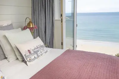 a bedroom with a bed with a view of the ocean at Emerald - Stunning Views - Free Parking and WiFi - Coffee Machine in Carbis Bay