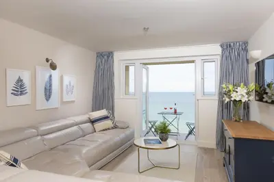 a living room with a couch and a view of the ocean at Emerald - Stunning Views - Free Parking and WiFi - Coffee Machine in Carbis Bay