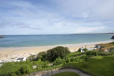 a view of a beach with people in the water at Emerald - Stunning Views - Free Parking and WiFi - Coffee Machine in Carbis Bay