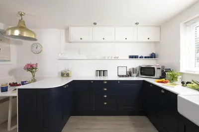 a kitchen with navy blue cabinets and white counter tops at Emerald - Stunning Views - Free Parking and WiFi - Coffee Machine in Carbis Bay