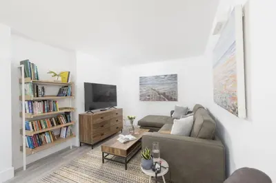 a living room with a couch and a tv at Redshank-Pets Allowed-River View-Cinema Room-Free Parking & WiFi in Looe