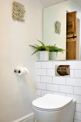 a white bathroom with a toilet and a mirror at Finest Retreats - Mill Stone Cottage in Nancledra