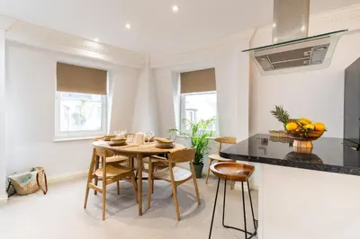 a kitchen and dining room with a table and chairs at 90A Tower Road in Newquay