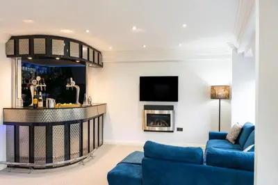 a living room with a blue couch and a fireplace at 90A Tower Road in Newquay