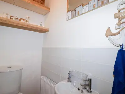a bathroom with a toilet and a sink at Poldam in St Austell