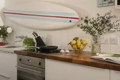 a kitchen with a counter with a bowl of fruit at Walters on The Digey - 100m to beach - pets allowed in St Ives