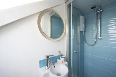 a bathroom with a sink and a mirror at Walters on The Digey - 100m to beach - pets allowed in St Ives