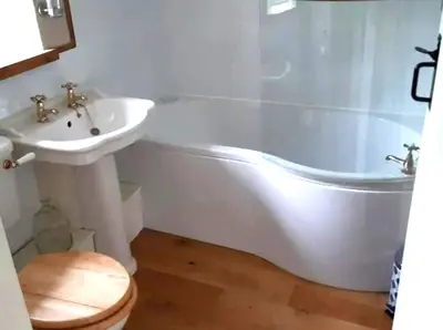 a bathroom with a sink and a tub and a toilet at Cottage - Sleeps 2 - River Lynher walks & fishing in Linkinhorne