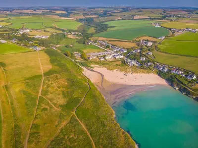 an aerial view of a beach and the ocean at Cornwall Holiday Home with Hot Tub & Sea views in St Merryn