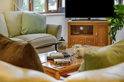a living room with a coffee table and a tv at 3 Bed in Polruan oc-l35010 in Fowey