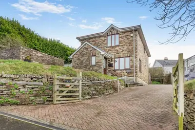 a stone house with a gate and a stone wall at 3 Bed in Polruan oc-l35010 in Fowey
