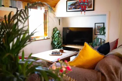 a living room with a couch and a table at Cosy Flat in the centre of St Ives in St Ives