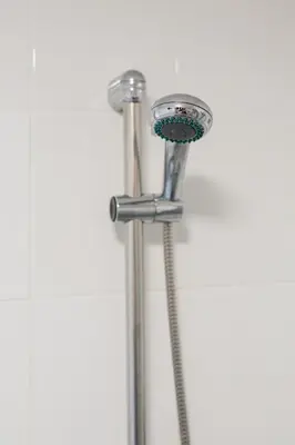 a shower with a shower head in a bathroom at Cosy Flat in the centre of St Ives in St Ives