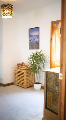 a room with a potted plant in the corner at Cosy Flat in the centre of St Ives in St Ives