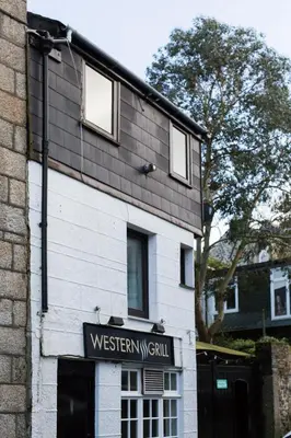a building with a sign that reads western w skill at Cosy Flat in the centre of St Ives in St Ives