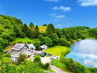 an aerial view of a house next to a lake at Steppes Lodge in Looe