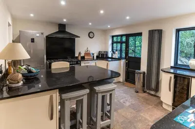 a kitchen with a large island in a kitchen at Steppes Lodge in Looe