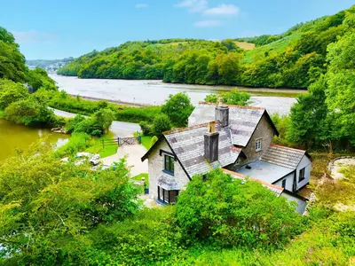 an aerial view of a house next to a river at Steppes Lodge in Looe