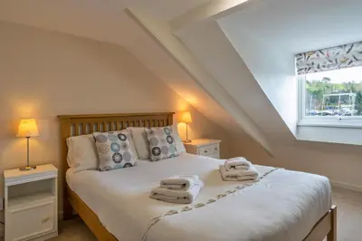 a bedroom with a bed with towels on it at Finest Retreats - Smugglers Loft at Mixtow Creek in Lanteglos