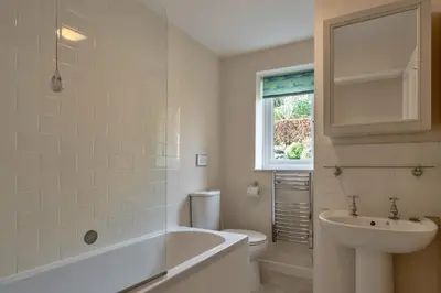 a bathroom with a tub and a toilet and a sink at Finest Retreats - Smugglers Loft at Mixtow Creek in Lanteglos