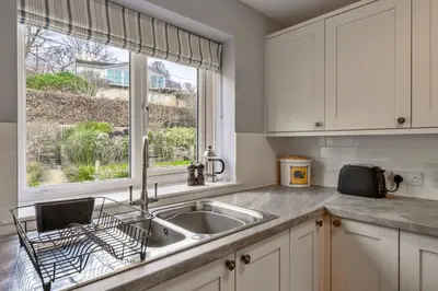 a kitchen with a sink and a window at Finest Retreats - Bosuns Loft at Mixtow Creek in Lanteglos