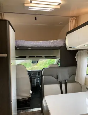 a view of the inside of a camper van with a bed at Raffy The Motorhome in St Merryn