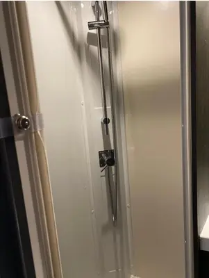 a shower stall with a glass door in a bathroom at Raffy The Motorhome in St Merryn