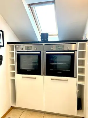 two microwaves in a kitchen with a window at Seaforth - Stunning Beach View Free Parking in Perranporth