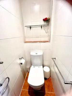 a white bathroom with a toilet and a sink at Seaforth - Stunning Beach View Free Parking in Perranporth