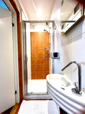 a bathroom with a sink and a shower at Seaforth - Stunning Beach View Free Parking in Perranporth