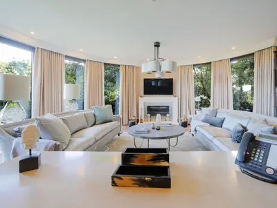 a living room with a couch and a table at Woodlands in Mawnan