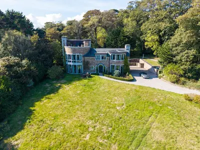 an aerial view of a large house on a grass field at Woodlands in Mawnan