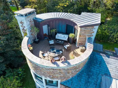 an overhead view of a swimming pool with a patio at Woodlands in Mawnan