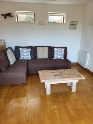 a living room with a couch and a coffee table at Carbis Bay Cabins in Carbis Bay