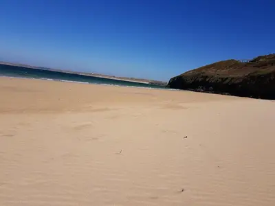 a sandy beach with the ocean in the background at Carbis Bay Cabins in Carbis Bay